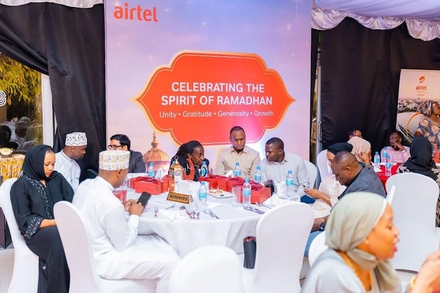 Guests seated at hosted tables beneath a “Celebrating the Spirit of Ramadhan” backdrop