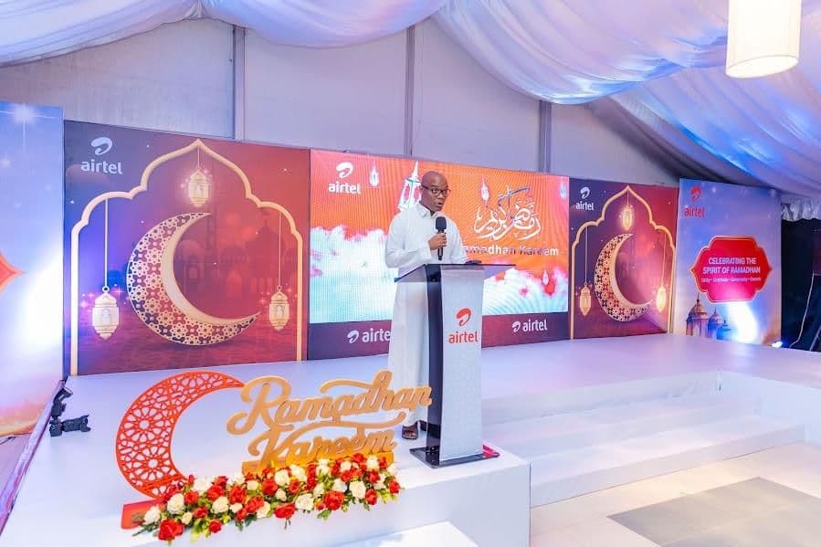 Ramadhan Kareem stage set with crescent moon and lantern graphics and a speaker at the lectern