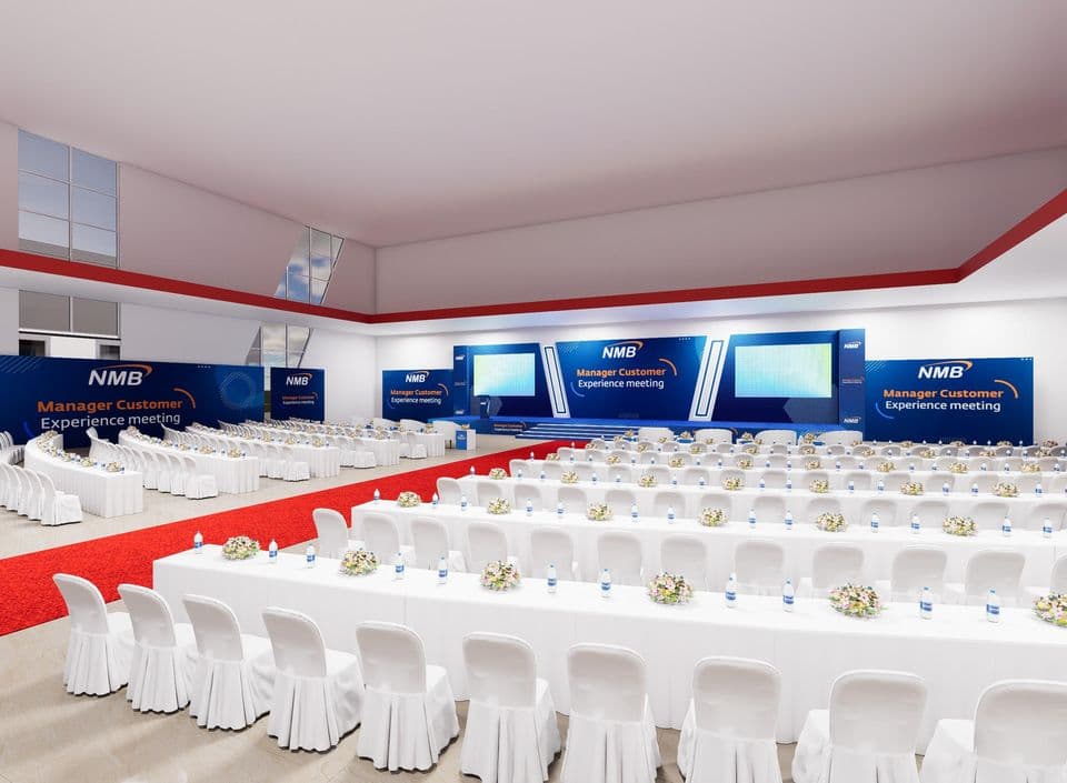 Visualization of NMB’s meeting hall: blue branded stage with twin LED screens and classroom-style seating